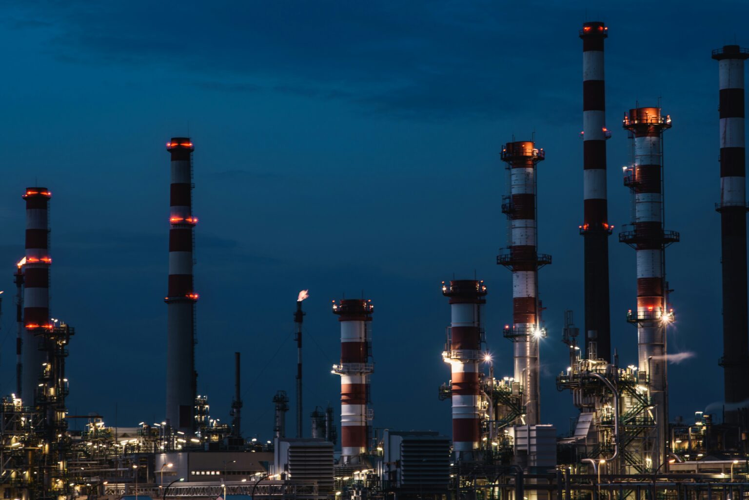 Oil refinery lit up at dusk